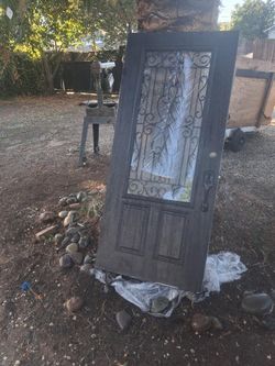 Beautiful iron and glass insert 36x80 front door. Can deliver and install for a small fee too
