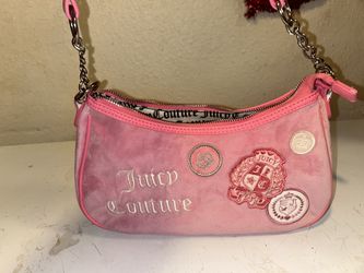 pink velour shoulder bag from Juicy Couture, featuring decorative patches and embroidered branding.