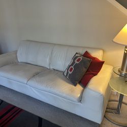 Conteporary modern  white leather sofa and matching love seat.