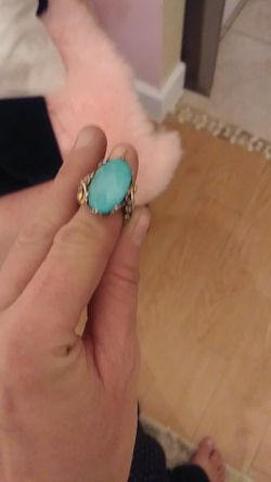 This designer ring ( forgot artists name for a sec) is 2 tone y 14kt gold & silver holds a long oval sleeping beauty turquoise in clear quartz.
