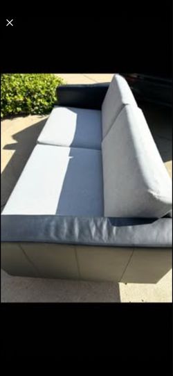 Black leather and gray fabric sofa