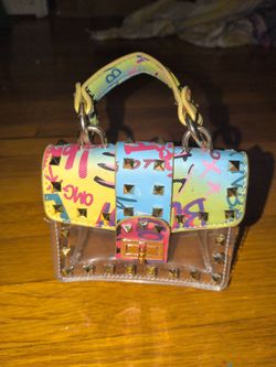 transparent PVC crossbody bag by Vabi Collections features gold-toned studs and a vibrant multicolor