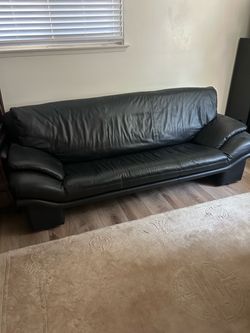 Black leather sofa, loveseat and chair.