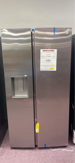 Stainless steel GE side-by-side refrigerator model GSS25IYPFS. This unit has a built-in water and ice dispenser on the left door. The interior is whit