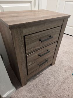 Wood grain night stand from Ashley's furniture