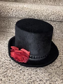 Black top hat with red flower