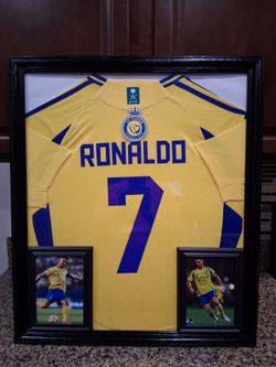 CRISTIANO RONALDO OF THE AL NASAR SOCCER TEAM, BRANDED,AUTHENTIC FRAMED JERSEY.
