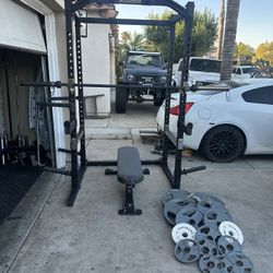 Powertec Power Rack with 7ft 45lbs bar plus 265lbs of Olympic weights