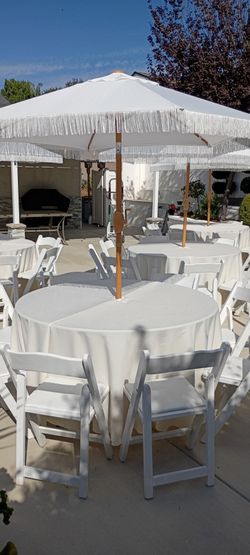 54" round tables, tablecloths, umbrellas, white wooden chairs