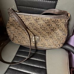 this item is a vintage Liz Claiborne shoulder bag featuring a monogrammed exterior, typically in brown and gold tones.