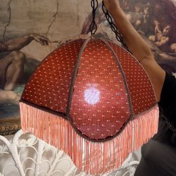 Victorian-style hanging pendant lampshade with a red fabric, polka dots, and pink fringe
