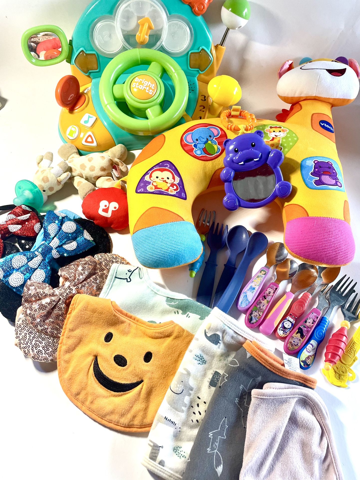 23 Piece Assorted Baby Toys Flatware Bibs Bows, Etc.