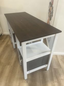 modern white and dark wood computer desk features integrated side storage shelves and two gray fabric storage drawers with rope handles