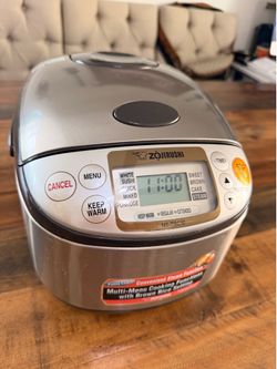 Used Zojirushi Rice cooker and warmer in silver color. Model no. NS-TSC10