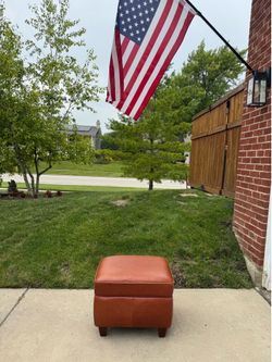 Brown leather ottoman. Foot rest