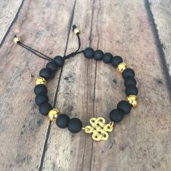 ** Men’s stone black agate bracelet with gold plated accessories.