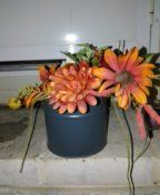 Artificial plants in a tin can holder very colorful nice and neat