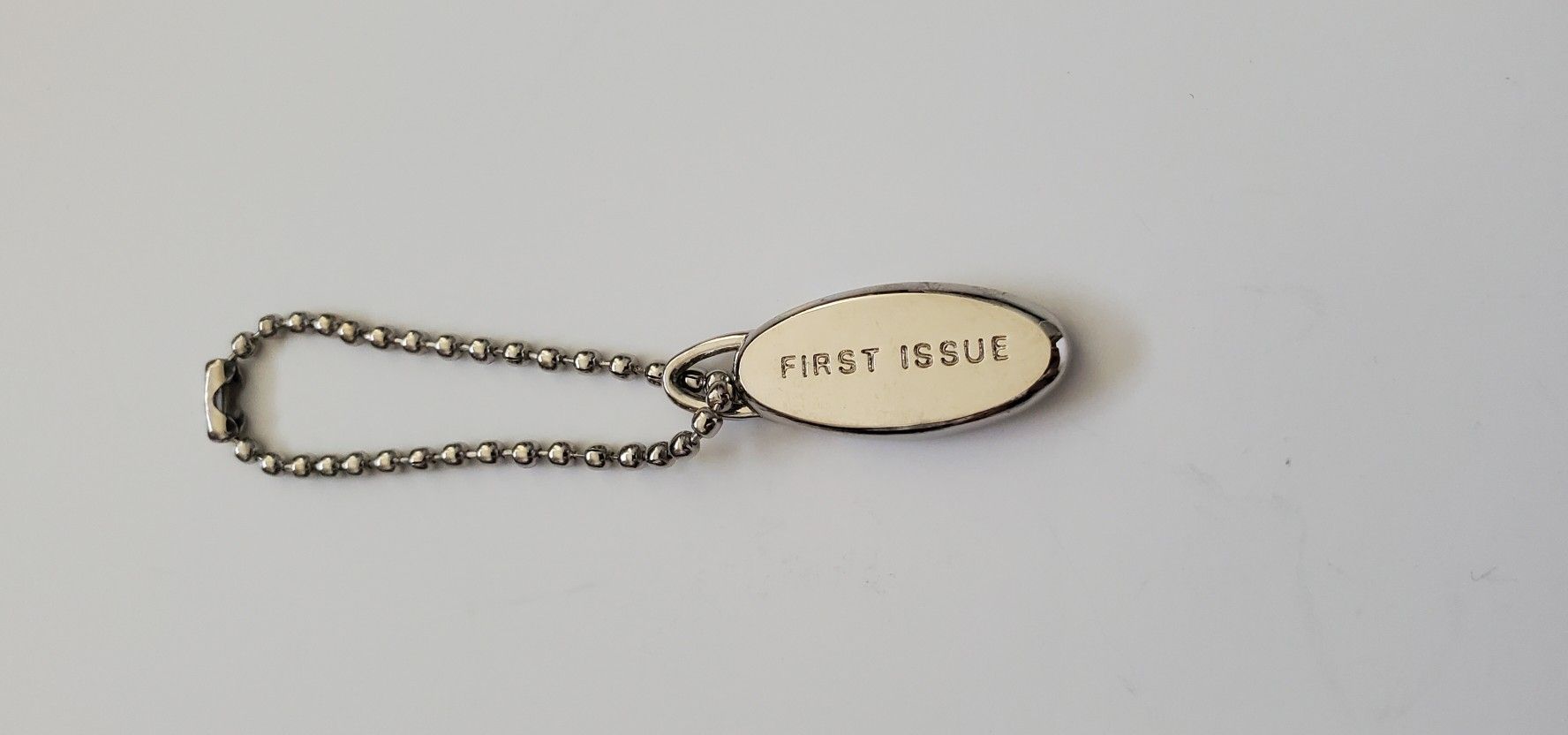 First Issue charm hang tag