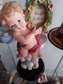 Baby boy angel holding frame