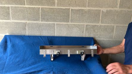 Stainless steel utility shelf with muffin broom holder