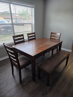 Dining table 4 chairs and a bench