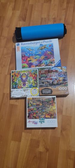 4 jigsaw puzzles and rollup puzzle mat