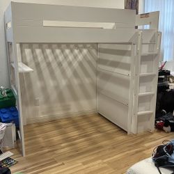 Loft bed with ladder and wardrobe closet.