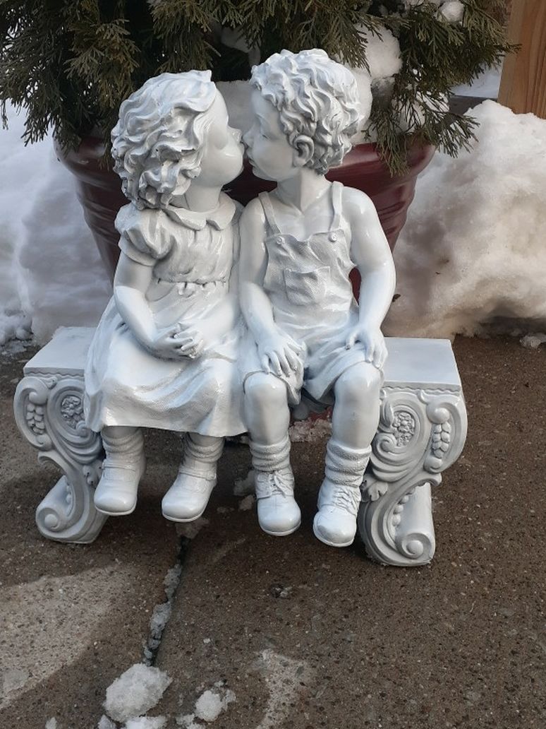 Small Outdoor Garden Boy And Girl Sitting On Bench