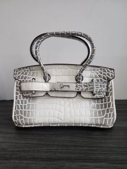 Elegant handbag featuring a white and gray croc-embossed pattern with silver-tone hardware