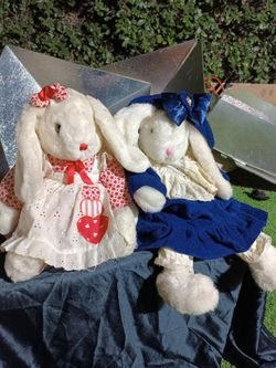 This item is a pair of vintage-style stuffed plush bunny rabbits