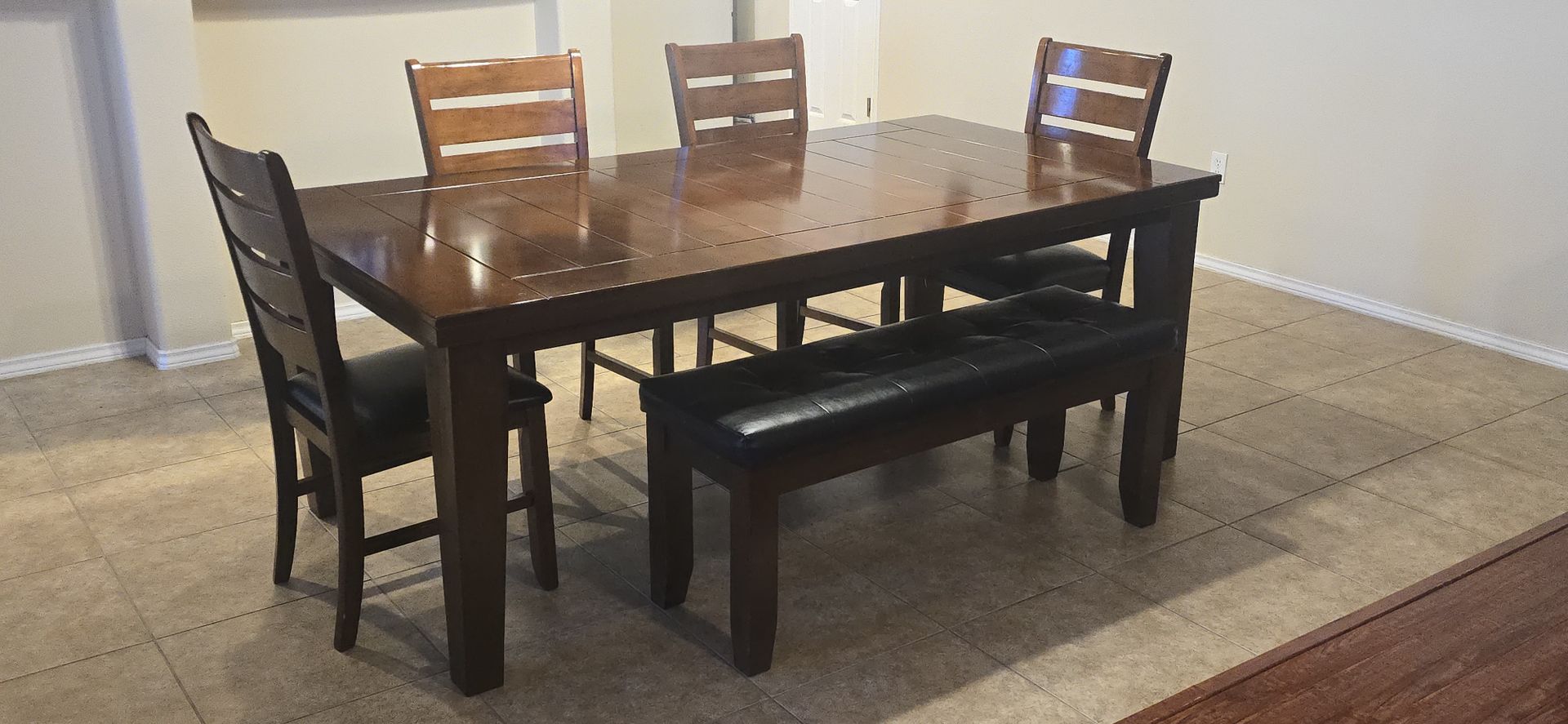 Crown Mark Bardstown table paired with upholstered side chairs and a dining bench.
