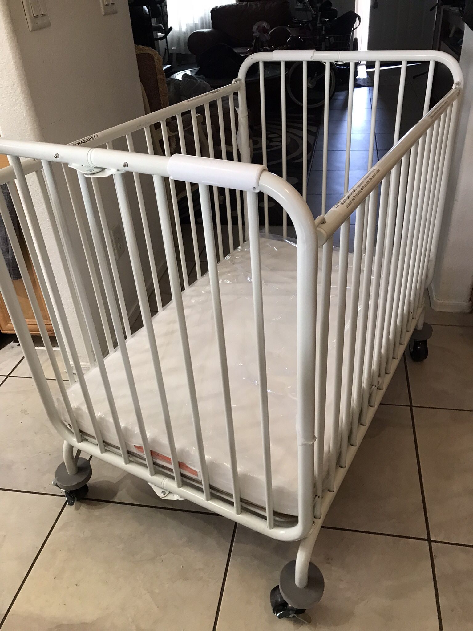L. A  Metal Folding Baby Crib