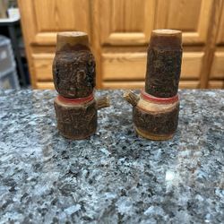 Wooden Hand carved pair of salt and pepper shakers. Size approximately 3 1/4 inches tall. Preowned. Made in Japan stamped on the bottom. Had been