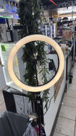 LED ring light features a flexible mount for holding a smartphone and Rgb lighting