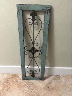 rustic turquoise and black scrollwork wall panel.