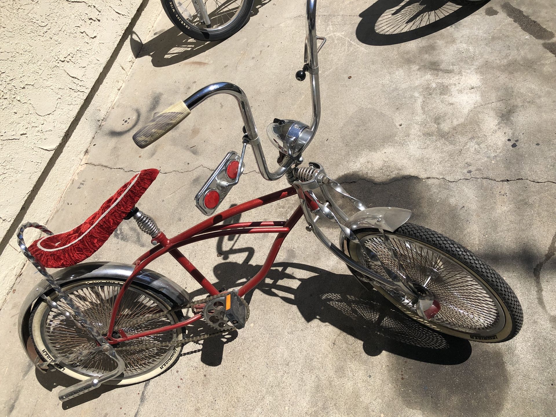 Lowrider bike candy apple red with 144 spokes.