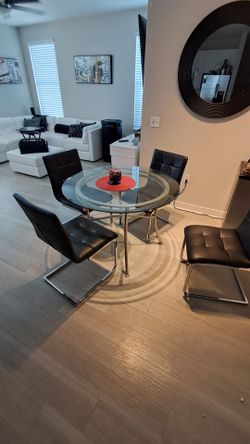 Modern Glass & Stainless Steel Dining Table Set – 4 Genuine Leather Chairs – Retail $2,200
Price: $400