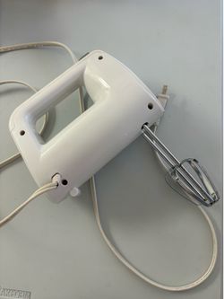 Rival handheld electric mixer, likely model HM-743 or similar, known for having multiple speed settings.