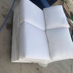 Brand new white armless 2 seater sofa asking $80