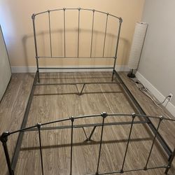 Queen iron bed frame — ornate floral detail, silver, good condition