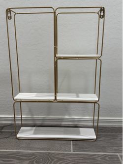Gold and white wall shelf