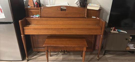 Upright piano with bench