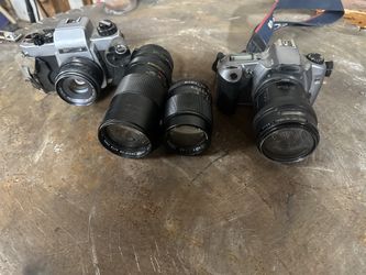 (2) 35mm film cameras with lenses