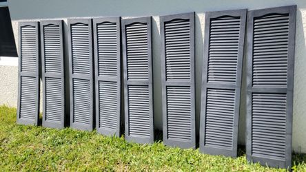 Black exterior open-louver vinyl window shutters. Location: SW Cape Coral, near Farmer Joe's.