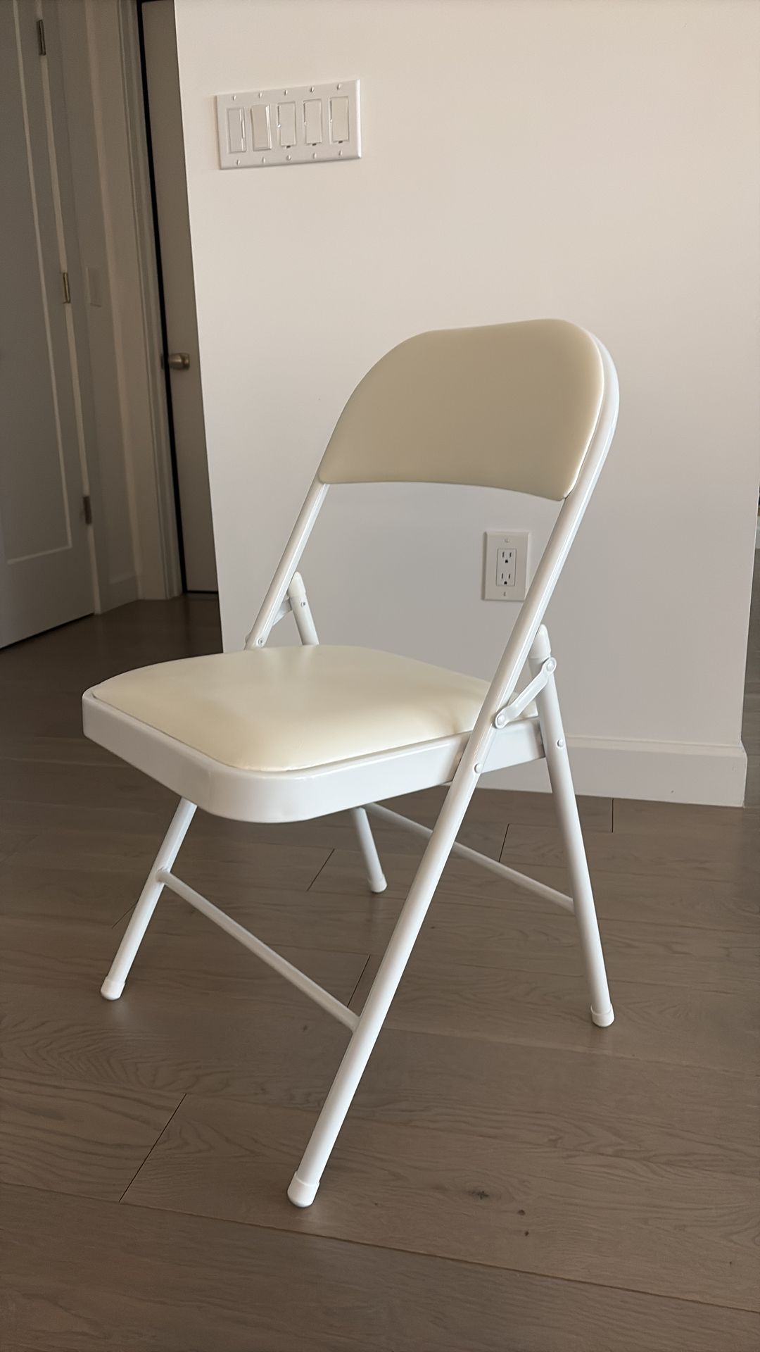 Four White folding chairs