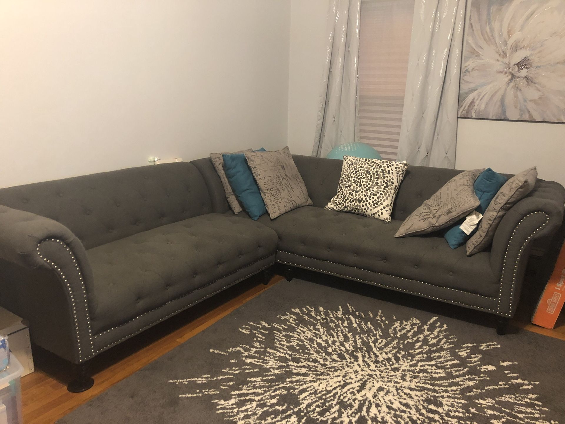 Grey tuffeted sectional couch
