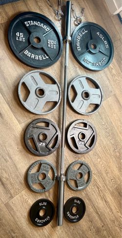 6 ft Steel NEW Olympic Bar with Pairs of Weight Plates in New Condition 45s, 35s, 25s, 10s and 5s. Total: 282 lbs