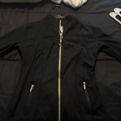 Lululemon, in black with gold zipper, size 6