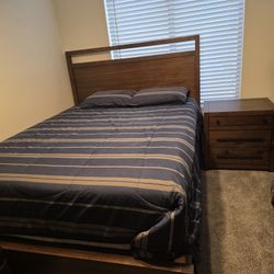 Queen size bed with two  side tables and  armoire.