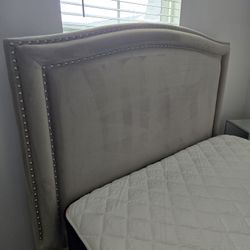 bed, beige upholstered, and glass nightstand.